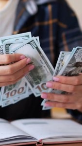 image of 100USD bills being counted.