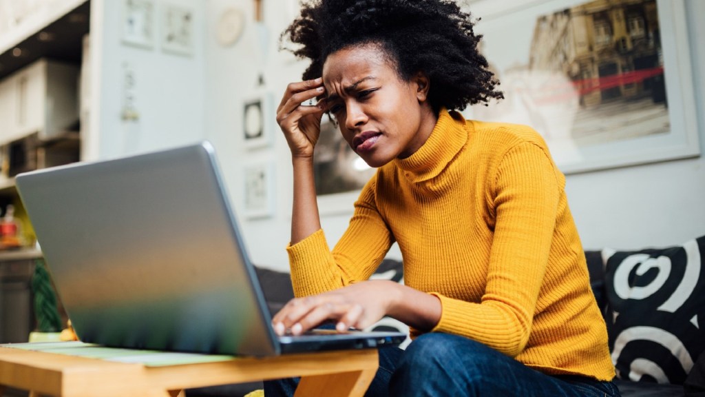 Young woman job applicant confused apprehensive laptop by Brothers91 from iStock.com